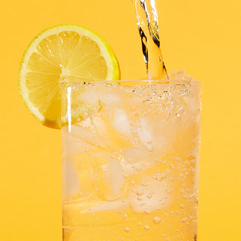 Glass of sparkling water with lemon garnish